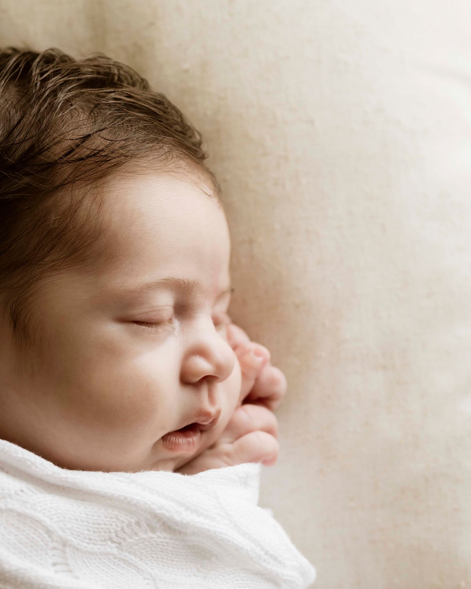 in-home newborn photography session with soft neutral tones in St Ives Chase