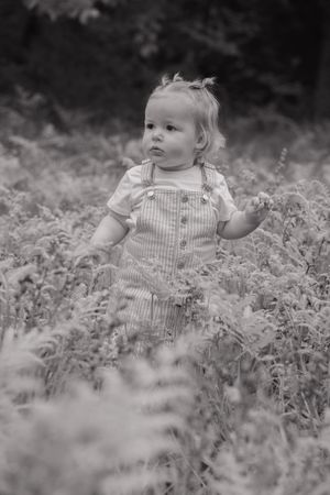 Black and white, little girl in field of flowers