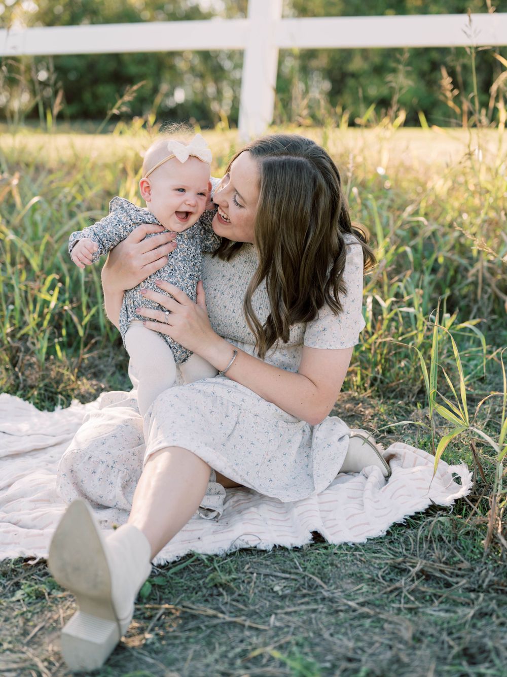 outdoor family session of mom and baby girl laughing together