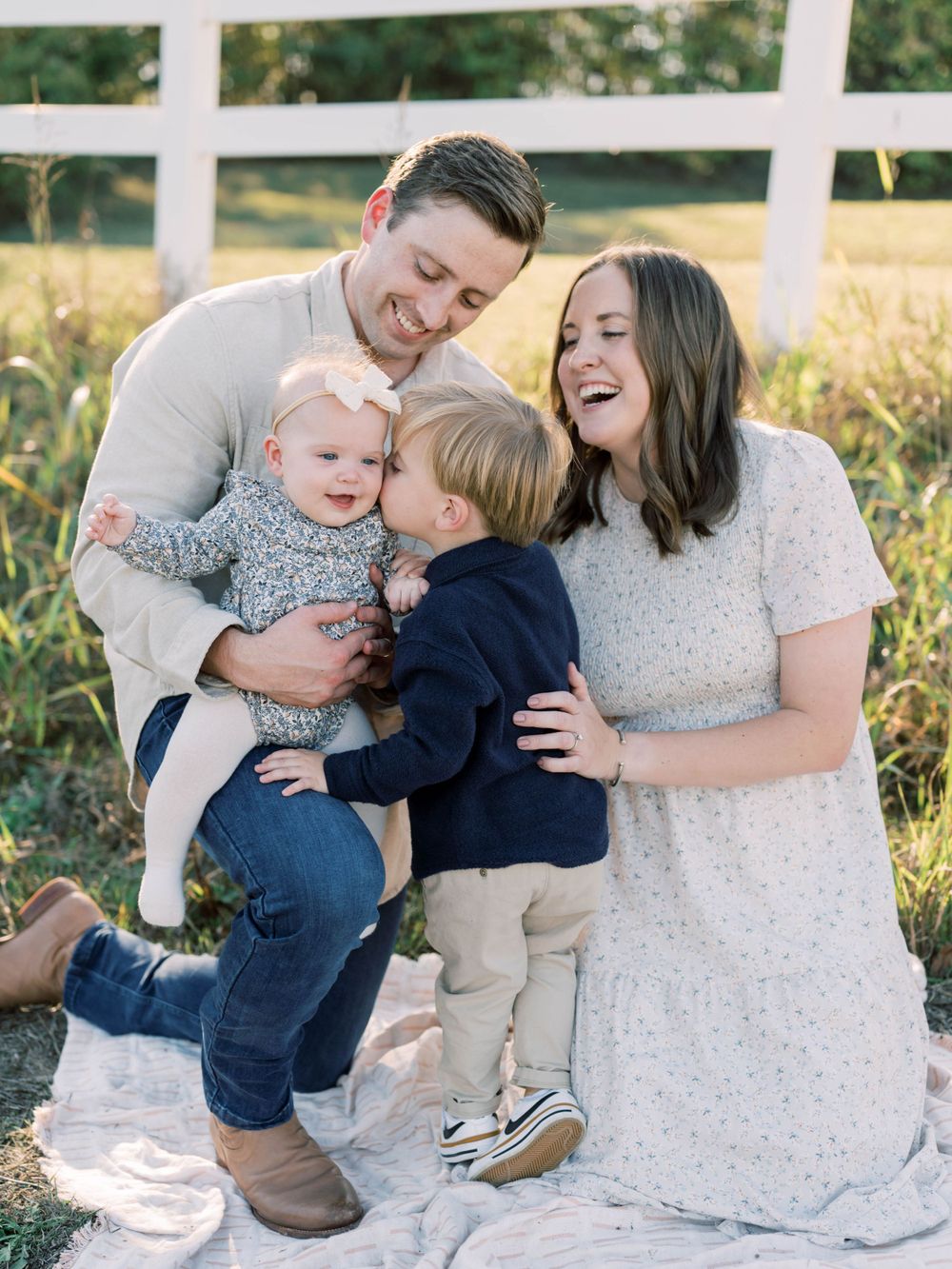 outdoor family session of a mom, dad, son, and daughter all laughing