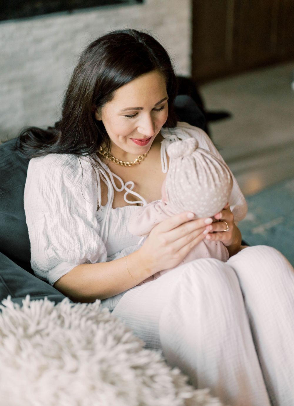 in-home newborn session where mom is looking at baby girl