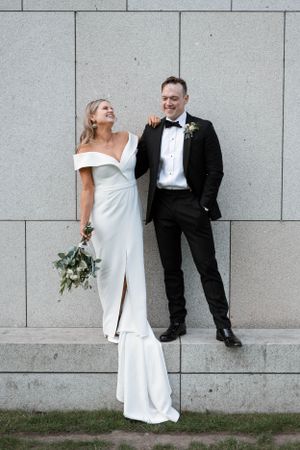 Couple share a laugh in Dun Laoghaire on a photoshoot after their wedding ceremony in The Royal Marine hotel in Dun Laoghaire, Ireland.