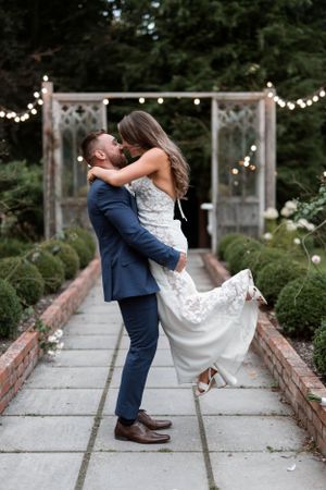 Couple sharing an intimate twirl in the gardens in Tinakilly House in Wicklow, Ireland. Summer wedding photos in Ireland.