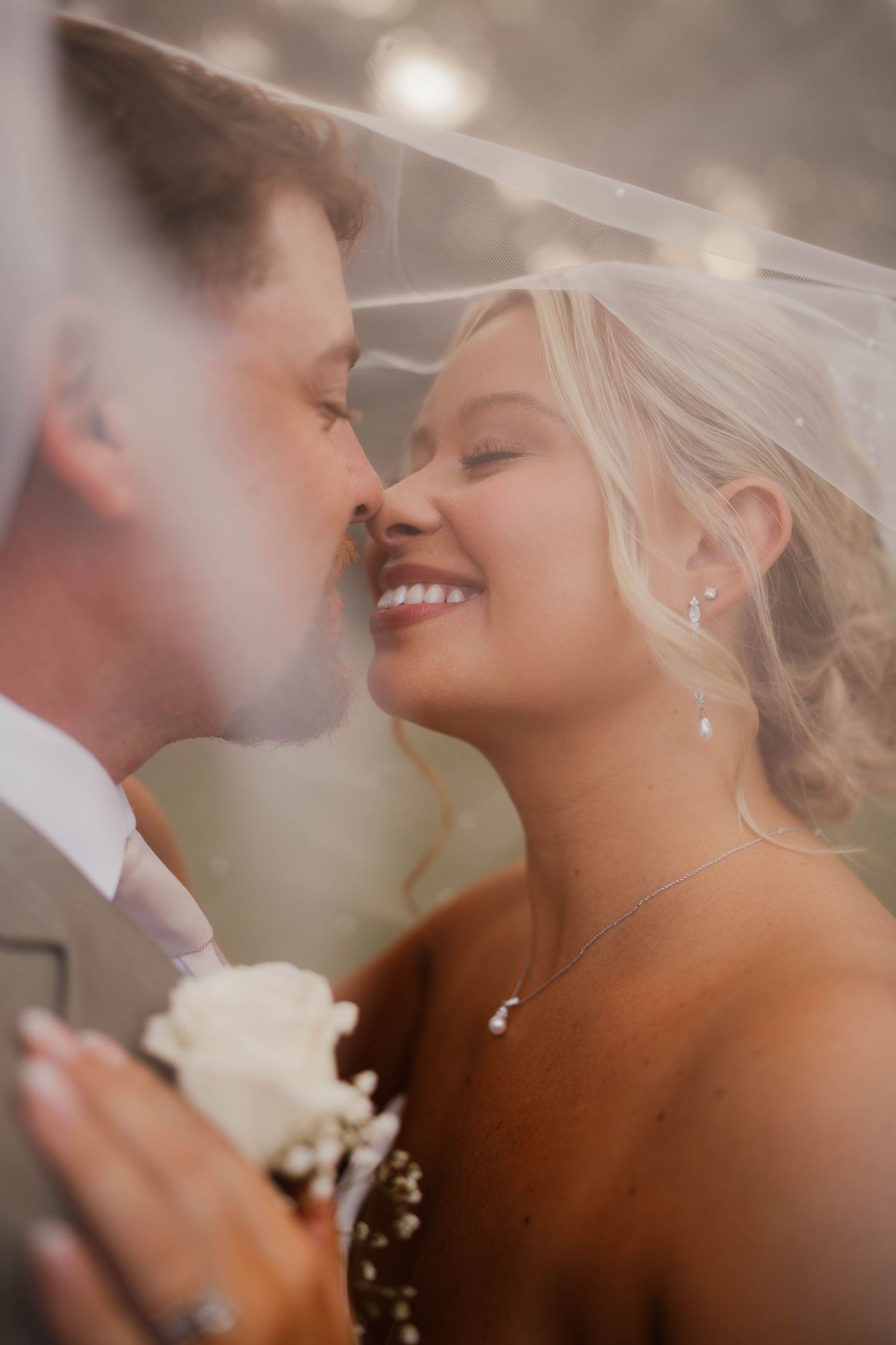 Tender sunset wedding portrait with couple sharing intimate moment.
