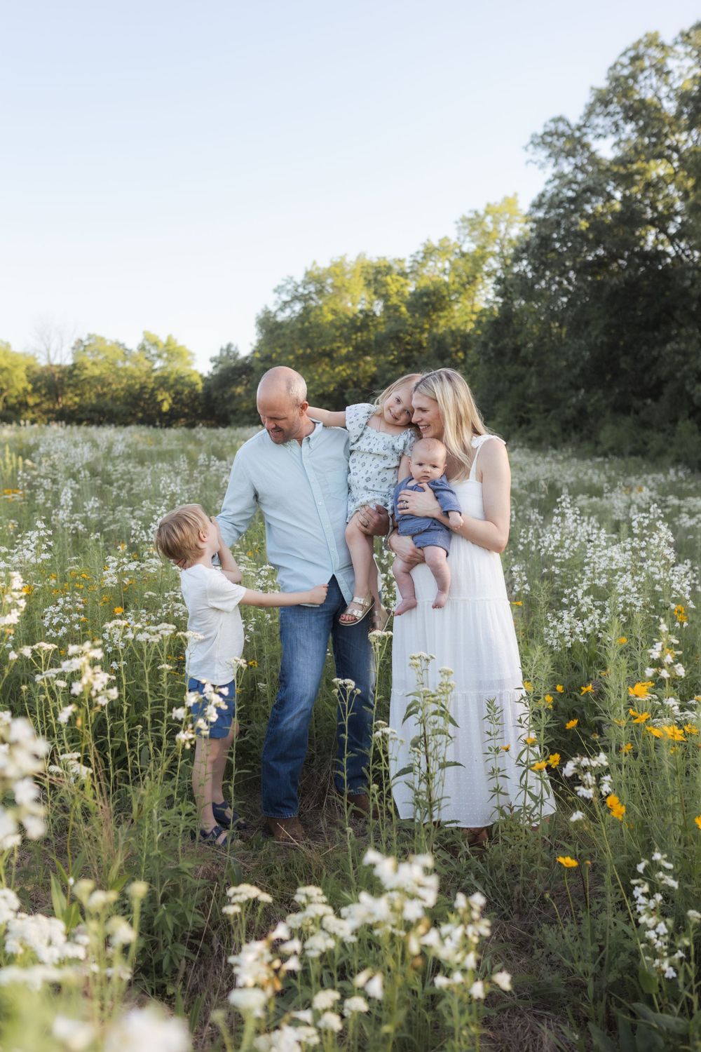 Family photos in a field of wildflowers in Columbia Missouri photographer