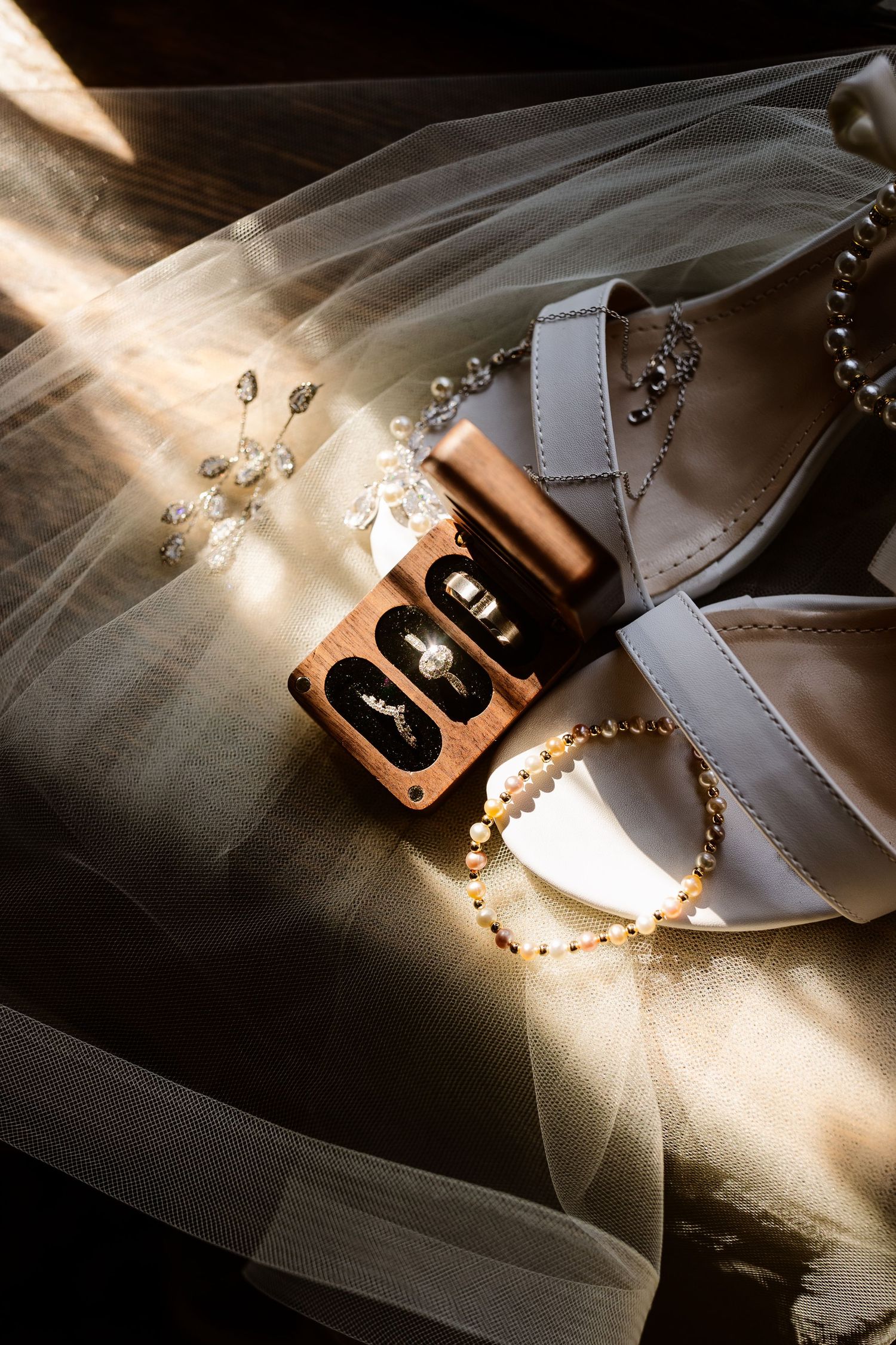 Wedding veil with sparkling details and decorative elements captured in dramatic lighting.