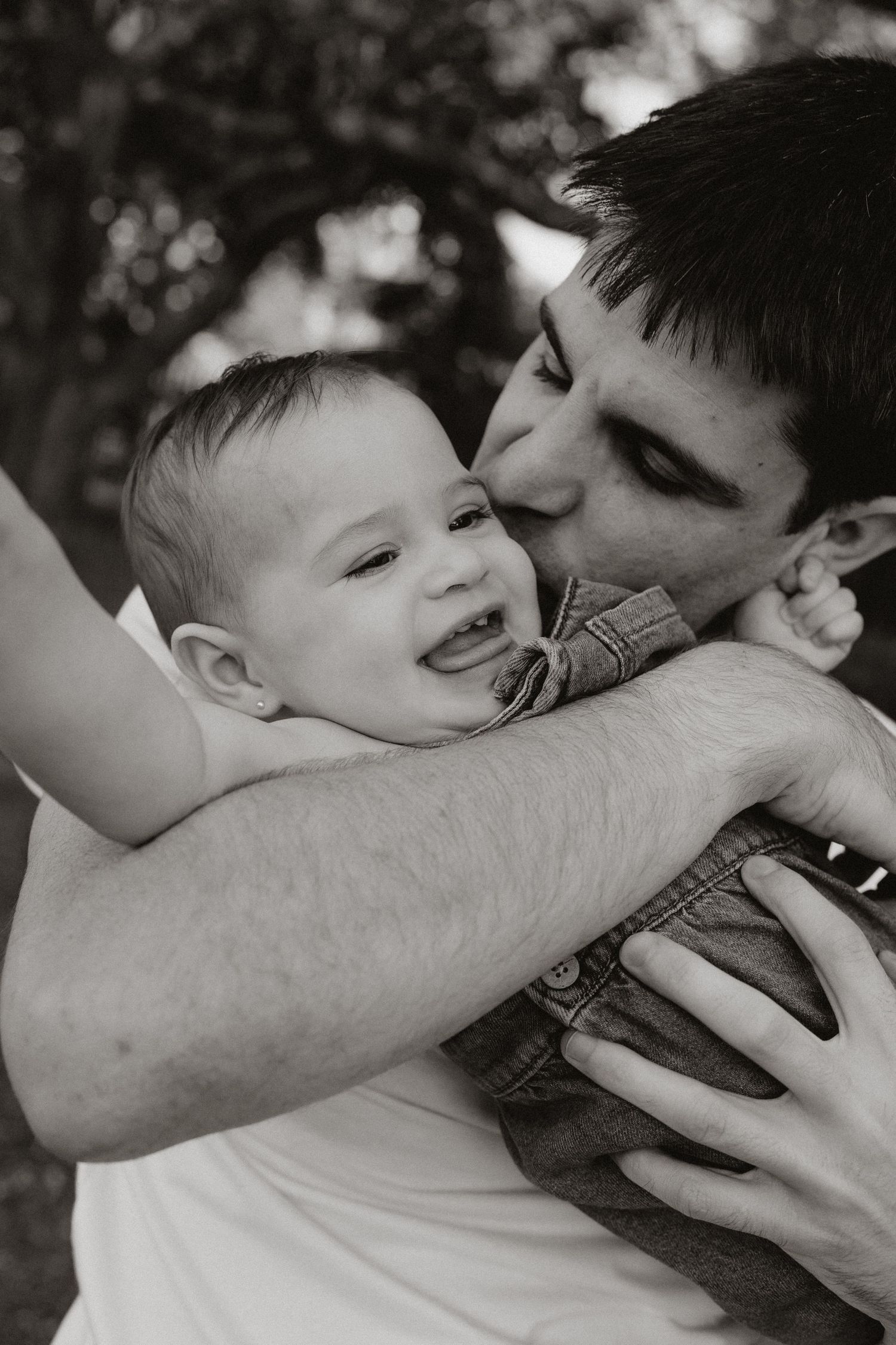 Black and white series capturing tender embraces between parent and child.