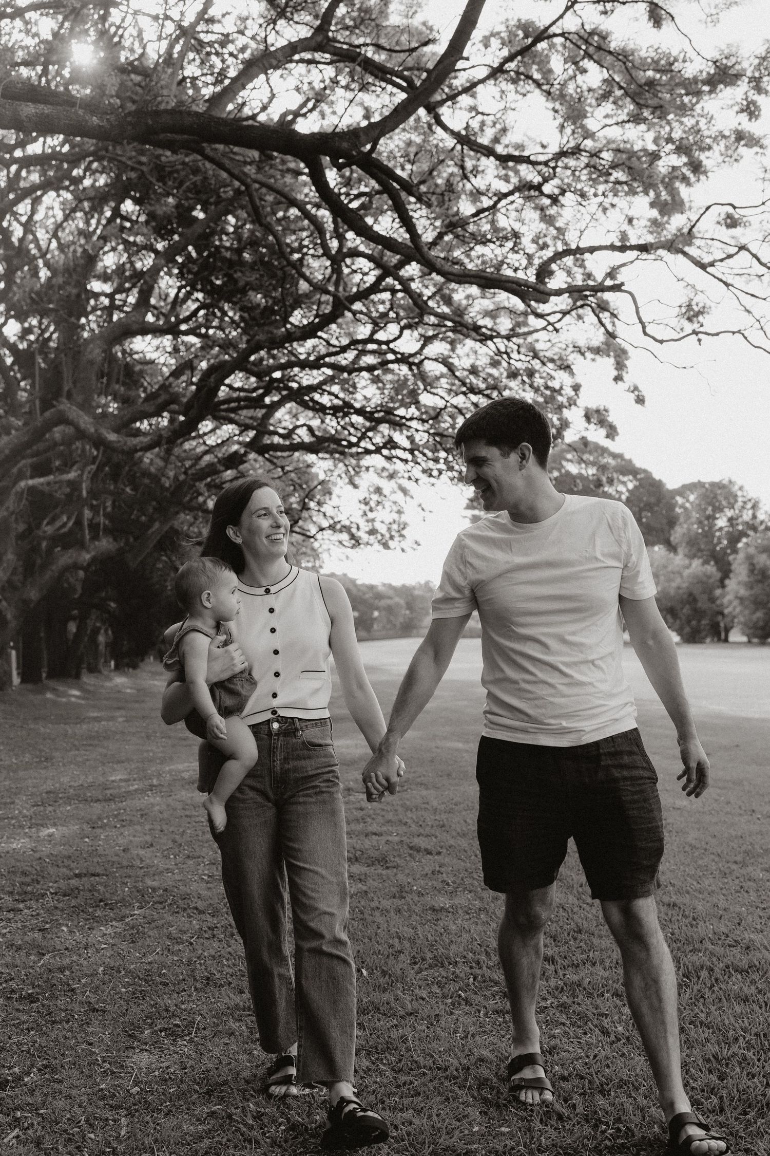Black and white photos of family members walking and interacting in a park setting.