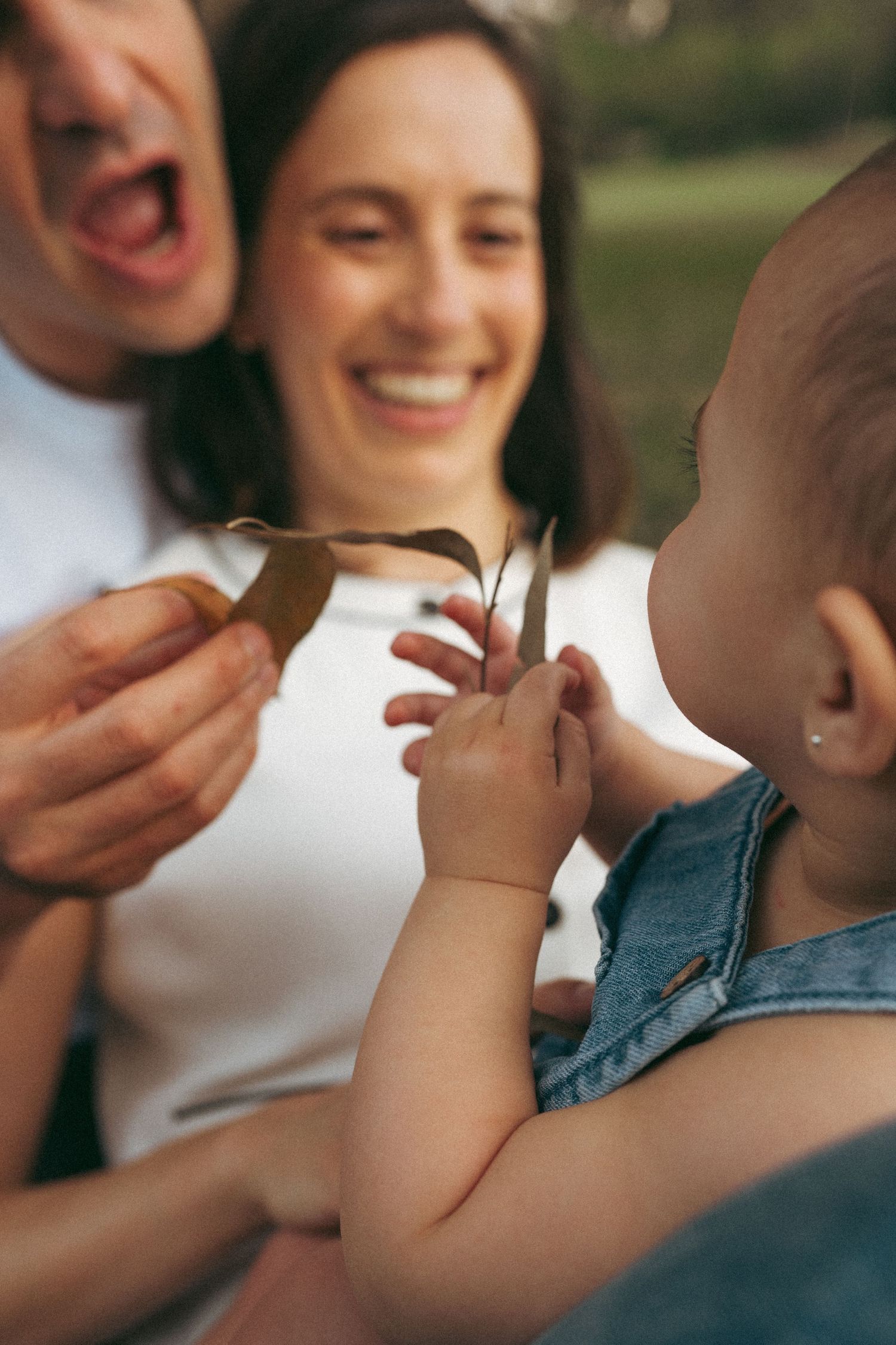 Close-up candid moments of family joy and laughter in natural lighting.