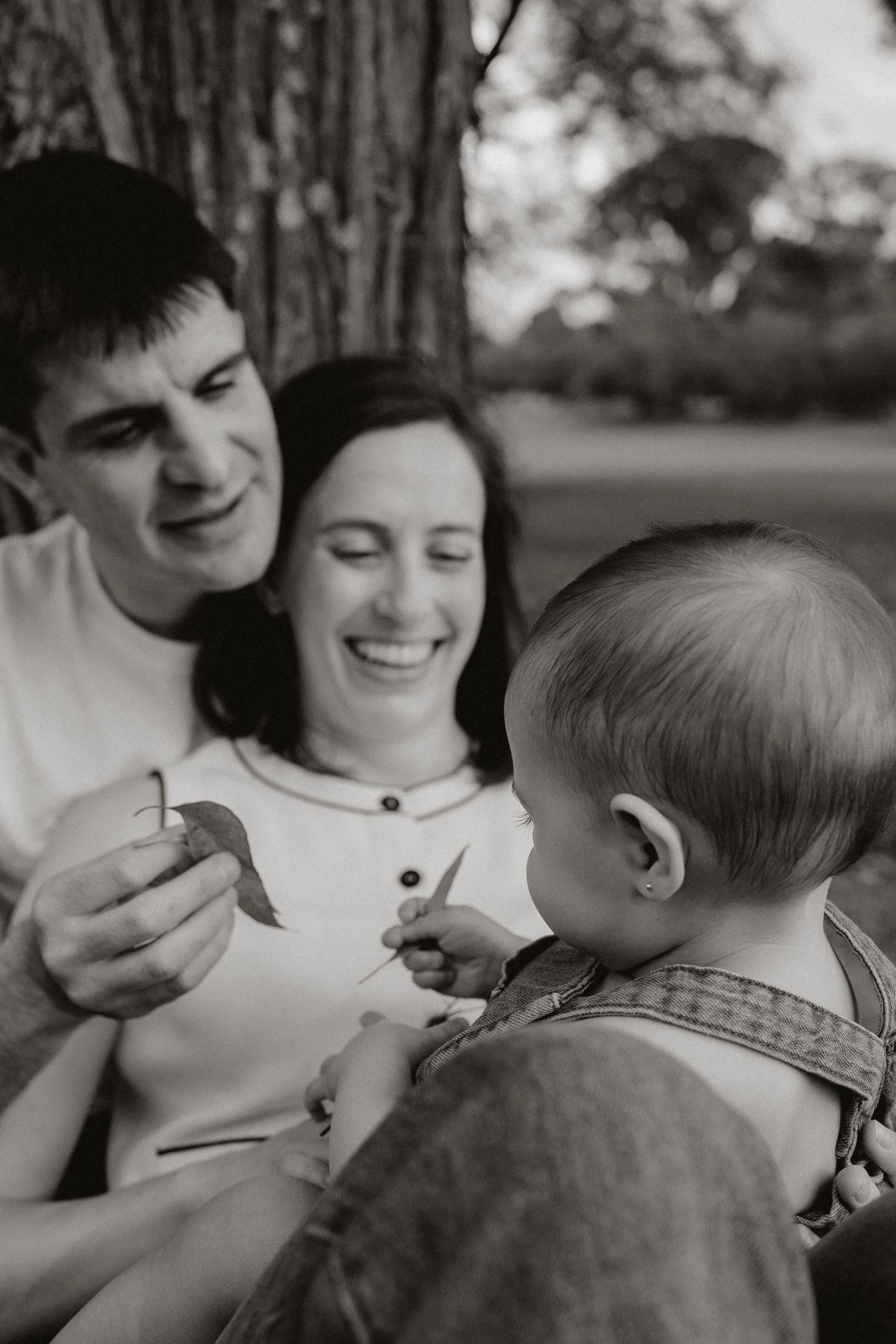 A tender moment of affection and laughter captured in black and white.