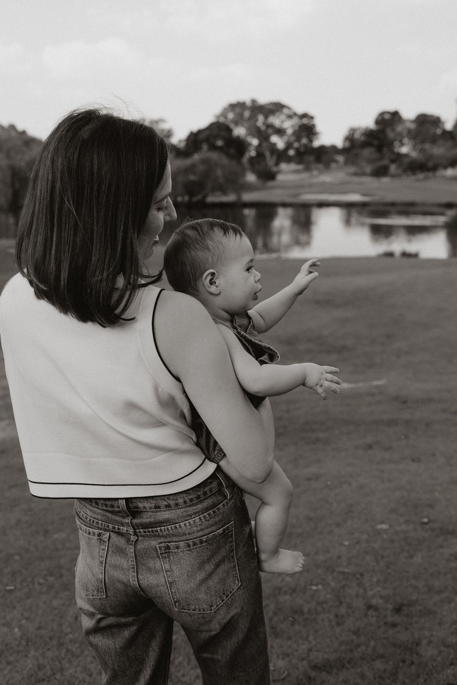 Black and white capture of a tender moment between parent and child outdoors.