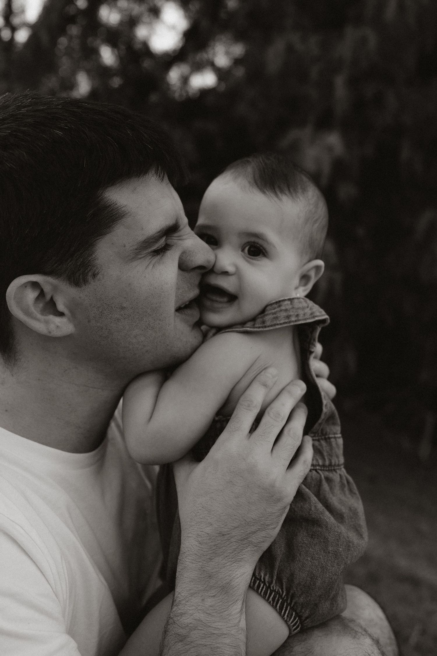 Tender black and white close-up portraits showing affectionate moments between two people.