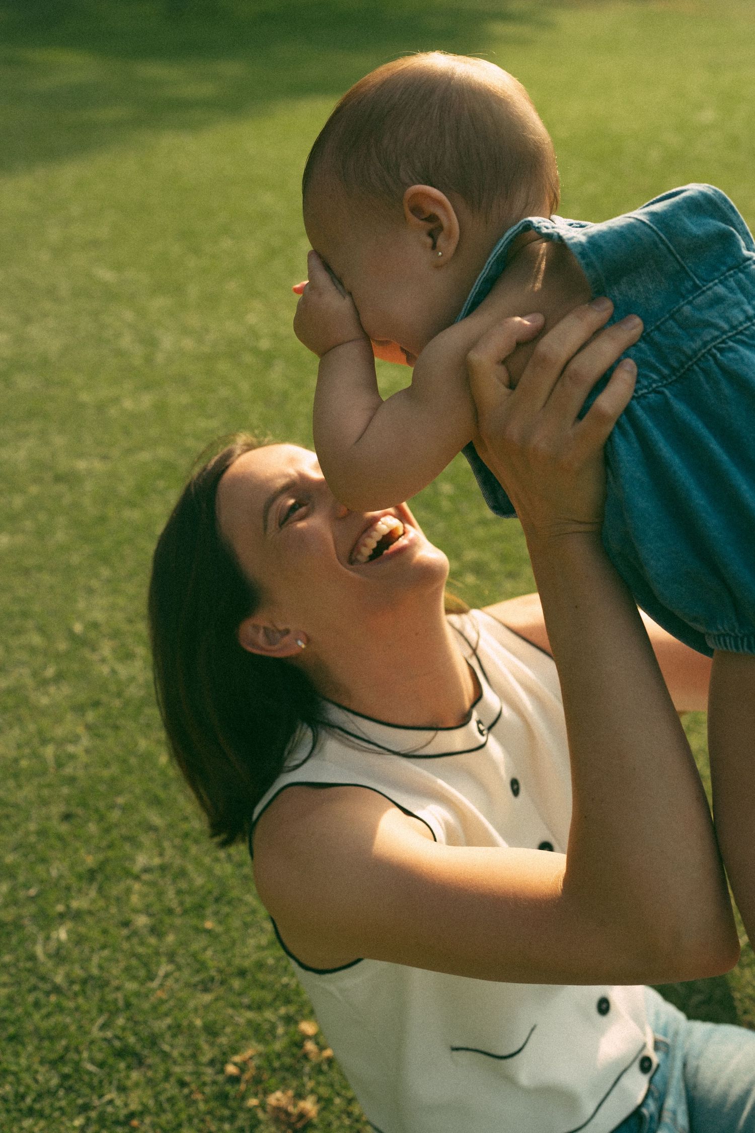 Candid sequence of people sharing a lighthearted moment on grass in sunlight.
