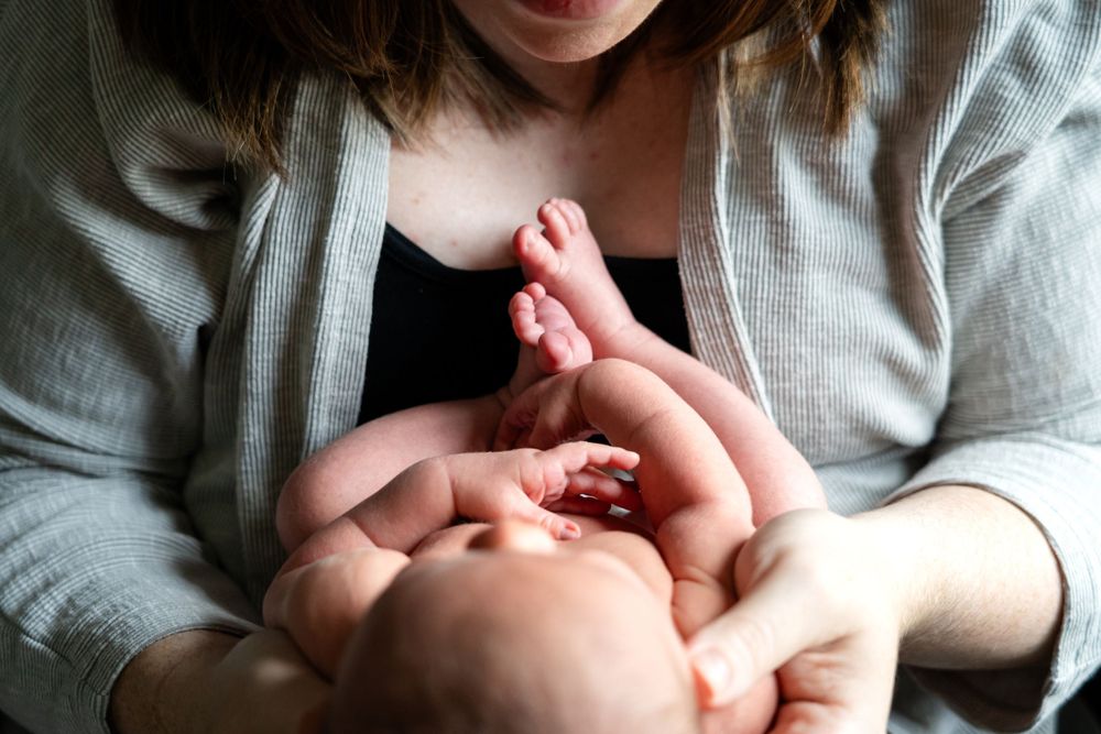 Tender moment between parent and infant during playtime.