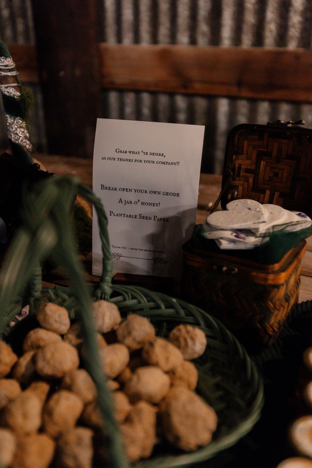 A wedding reception detail shot showing a note card and plate of appetizers on a rustic table.