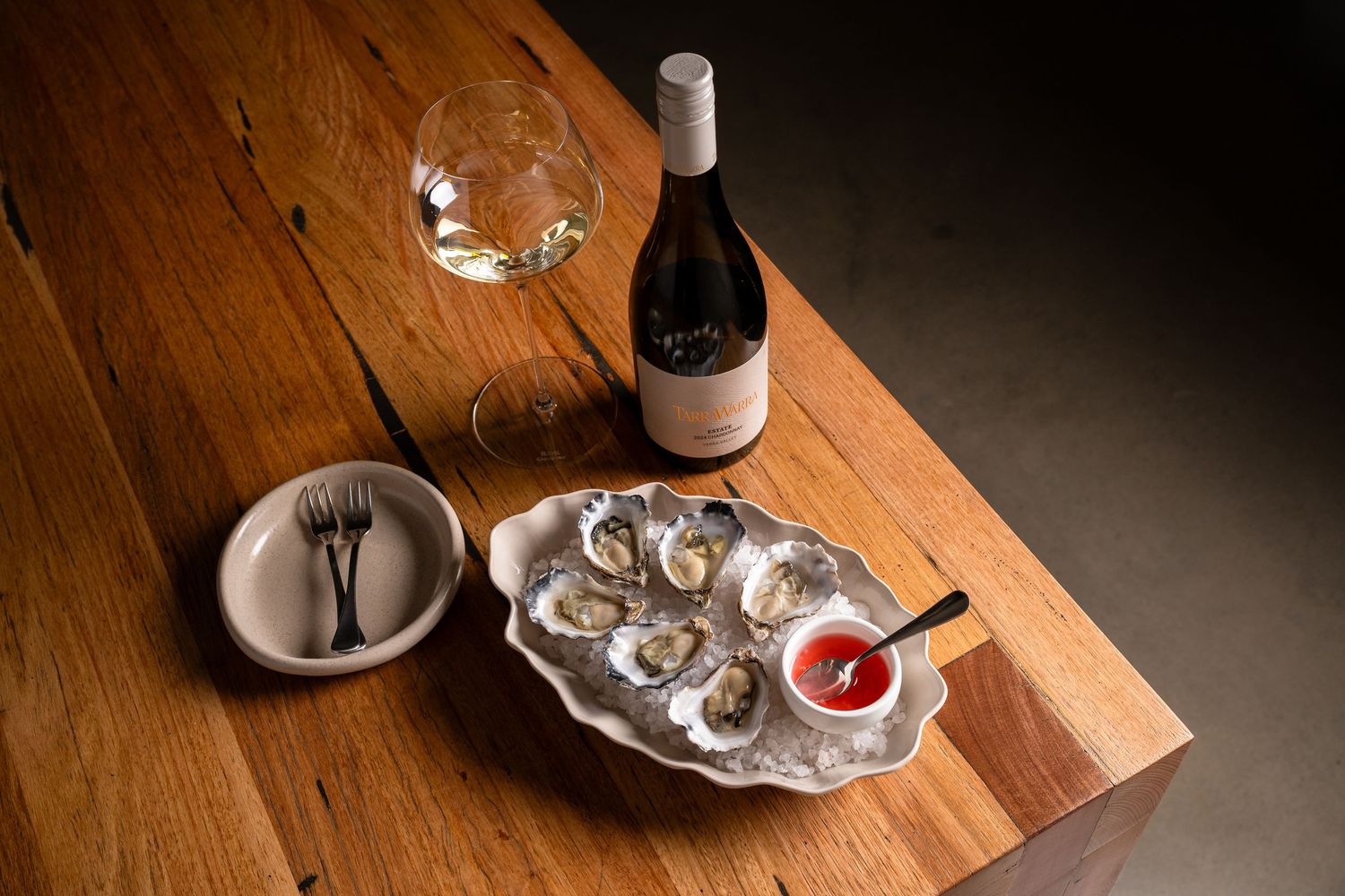 Fine dining experience with multiple courses and wine glasses on wooden table