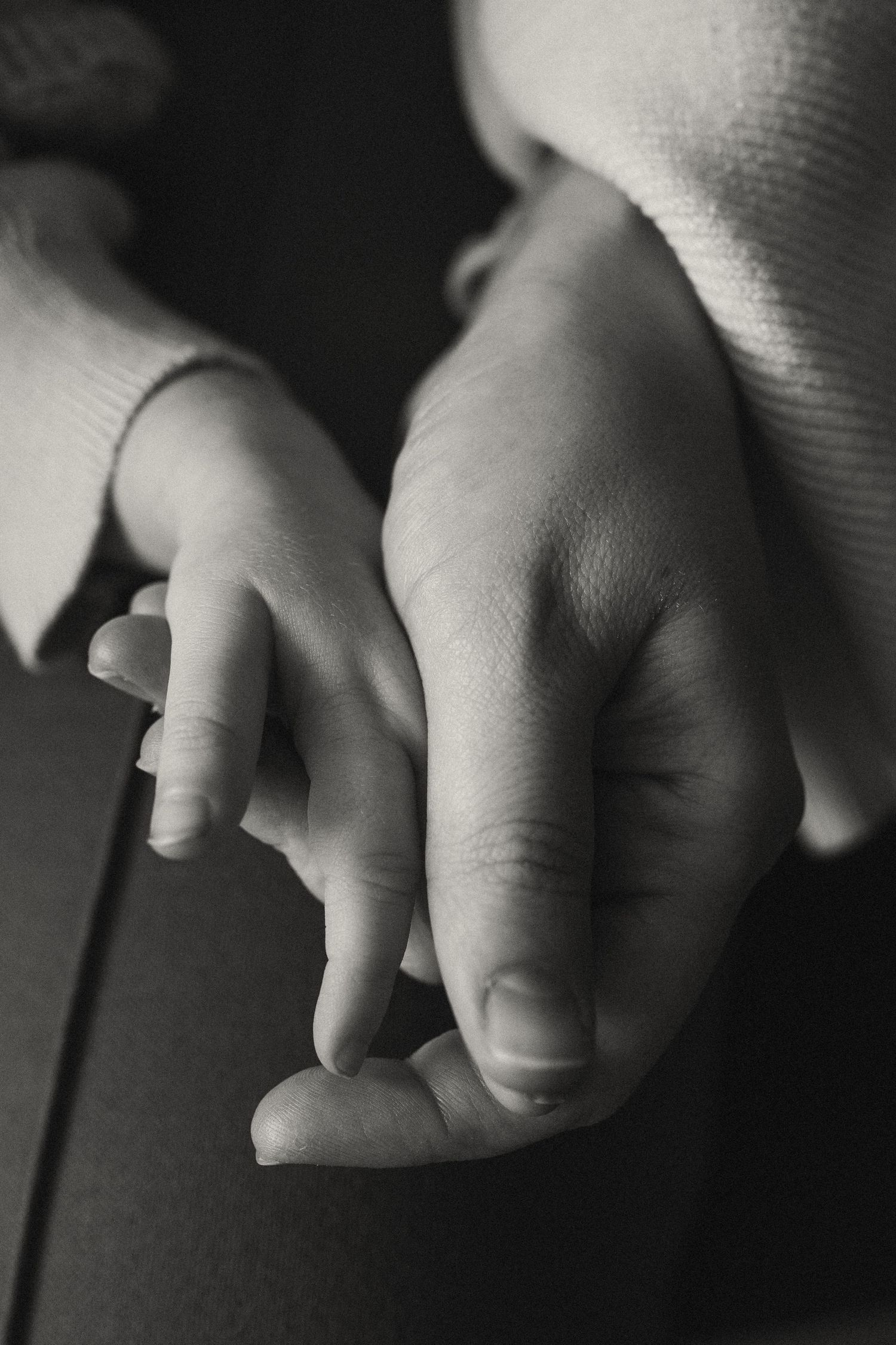 Artistic black and white close-up of small fingers.