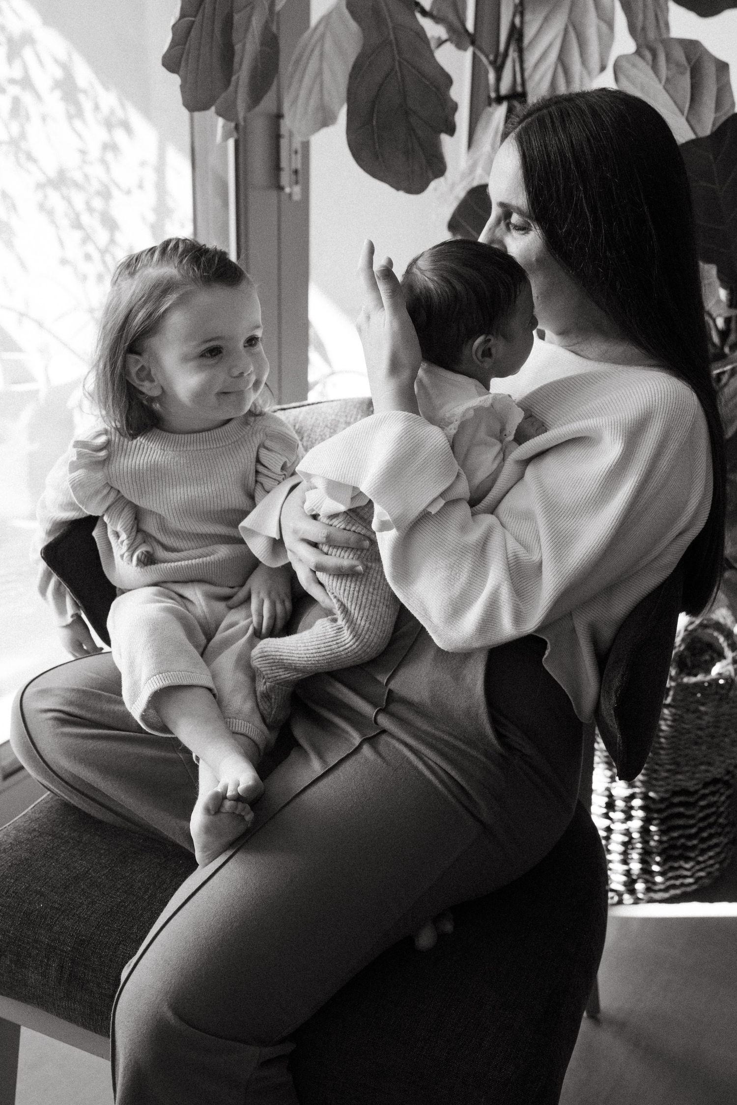 Black and white candid moment of parent and child embracing.