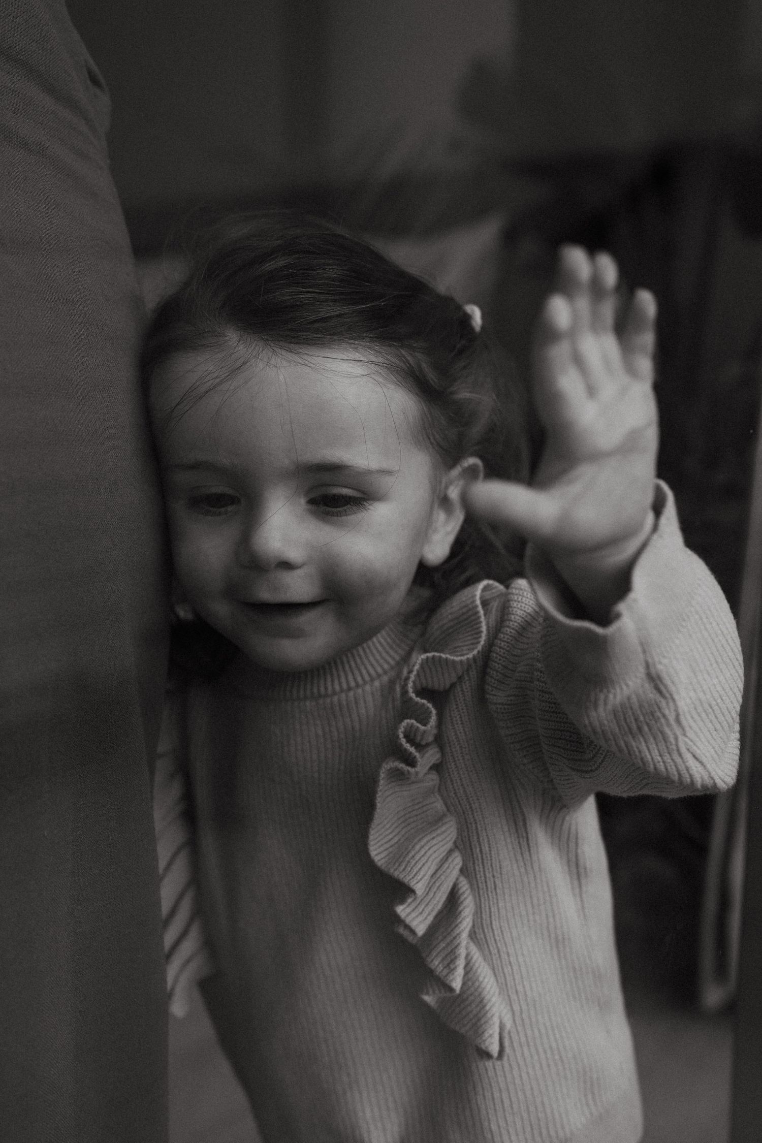 Black and white sequence showing playful movement in a cozy indoor setting.