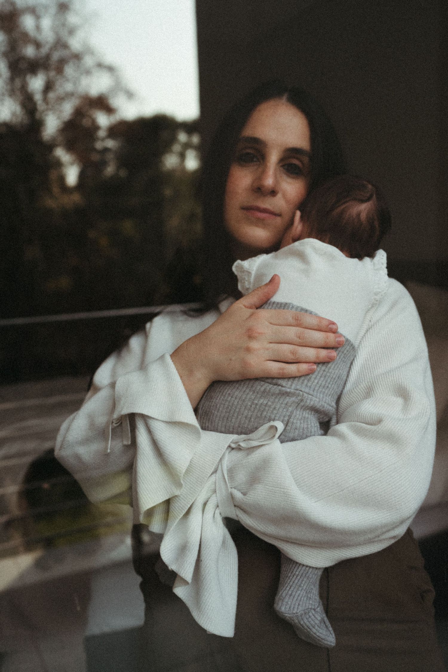 Artistic low-light portrait series featuring soft white clothing and intimate poses.
