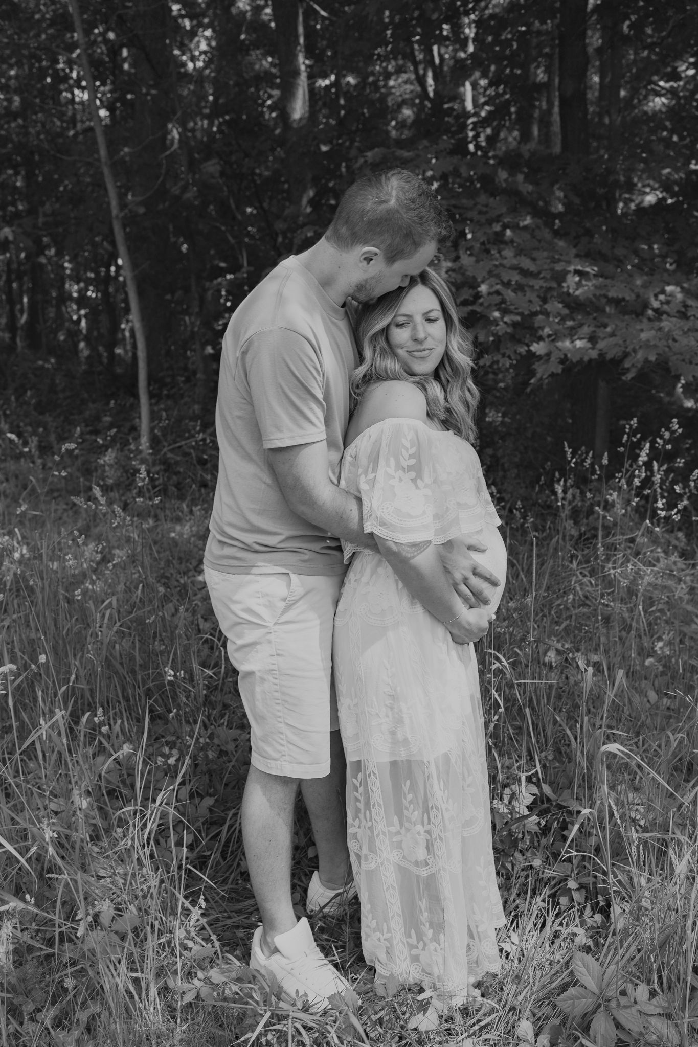 Black and white maternity photos captured in natural woodland setting taken in Concord Michigan.