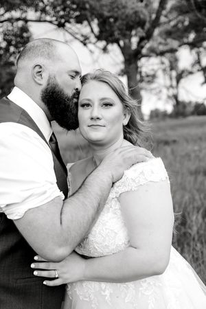 Black and white intimate wedding portraits show tender moments between newlyweds in outdoor setting.