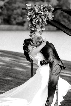 Romantic black and white wedding photo sequence showing a couple embracing in a garden with flowing veil and floral crown.