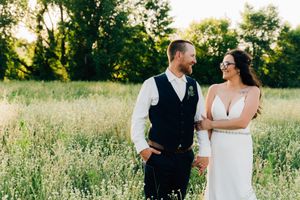 Wedding couple poses together in a beautiful wildflower field at golden hour.