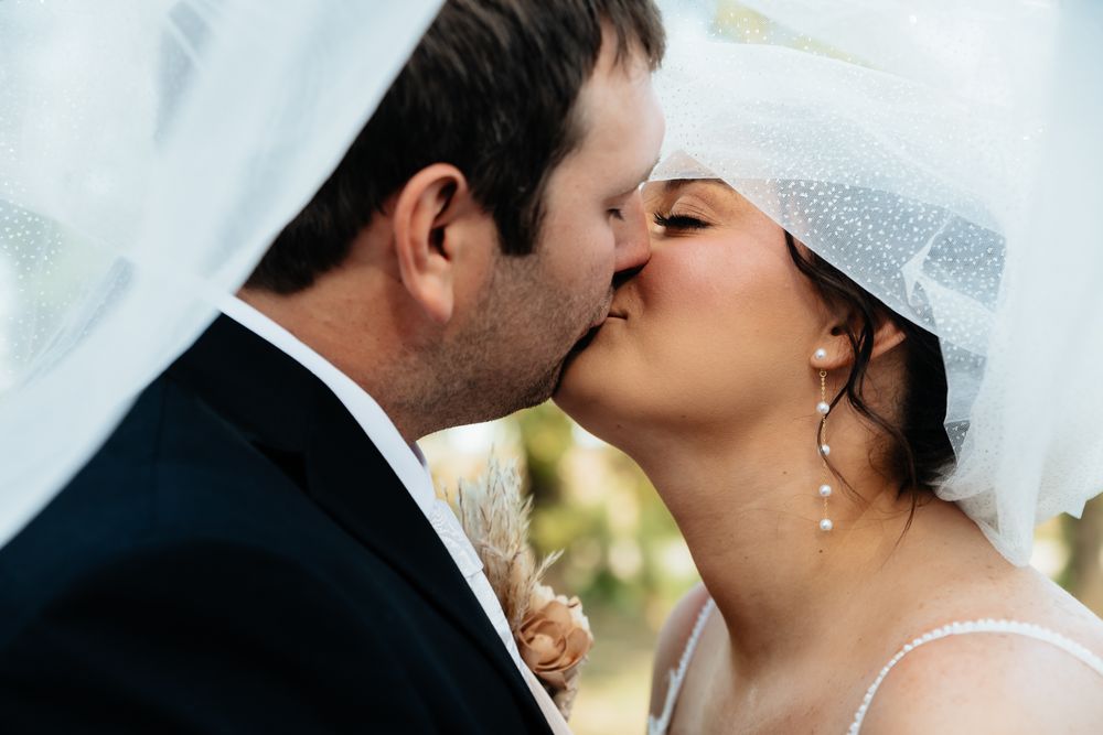 Romantic wedding couple shares intimate kisses in sequence of five connected photos.