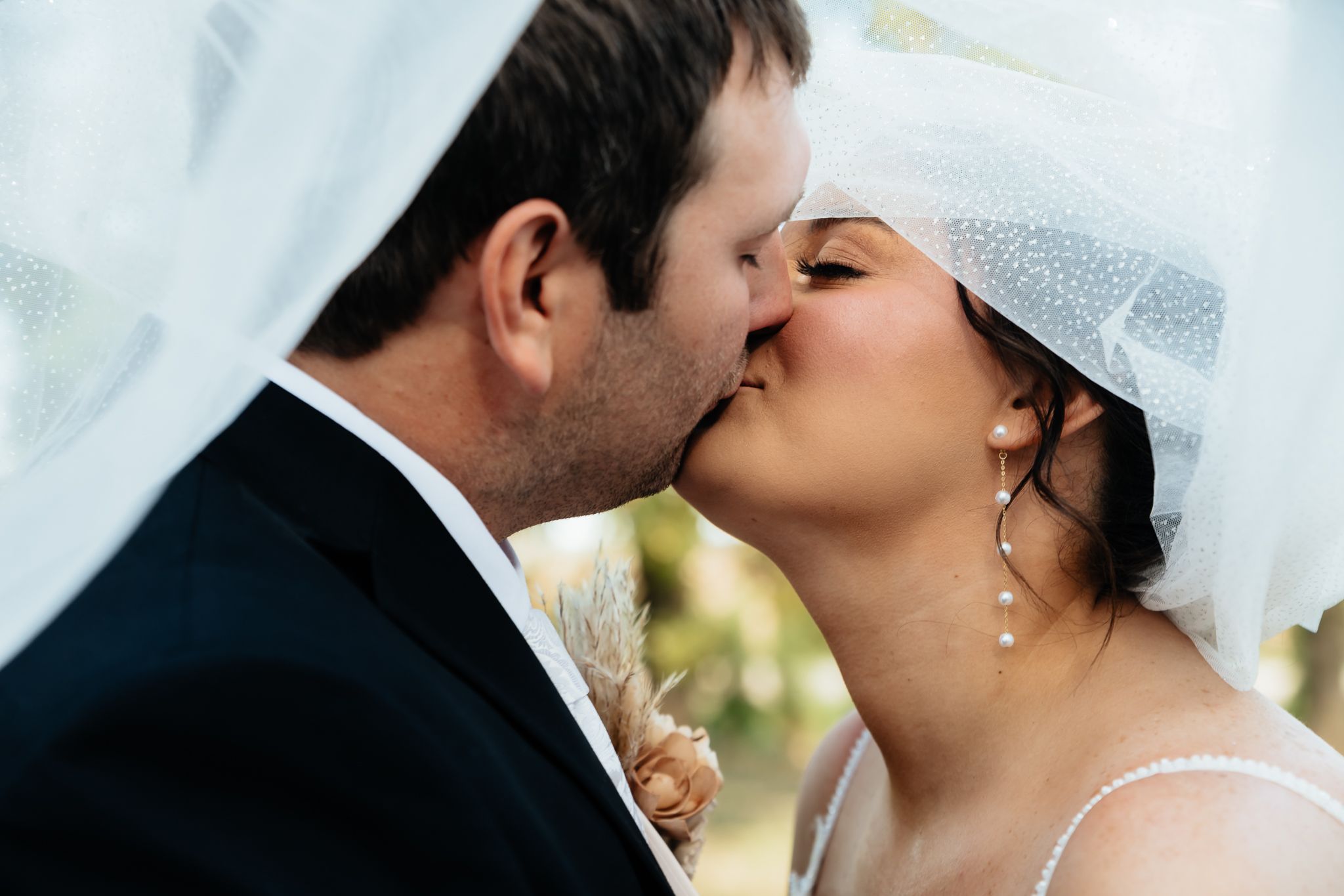 Romantic wedding couple shares intimate kisses in sequence of five connected photos.