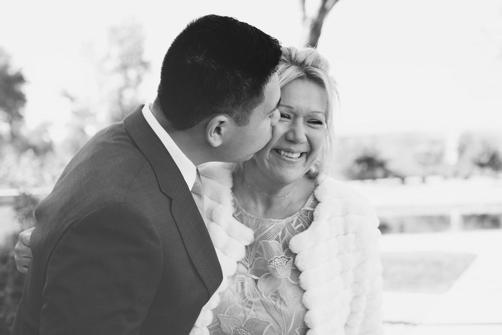 Intimate black and white portrait of a couple sharing a tender moment.