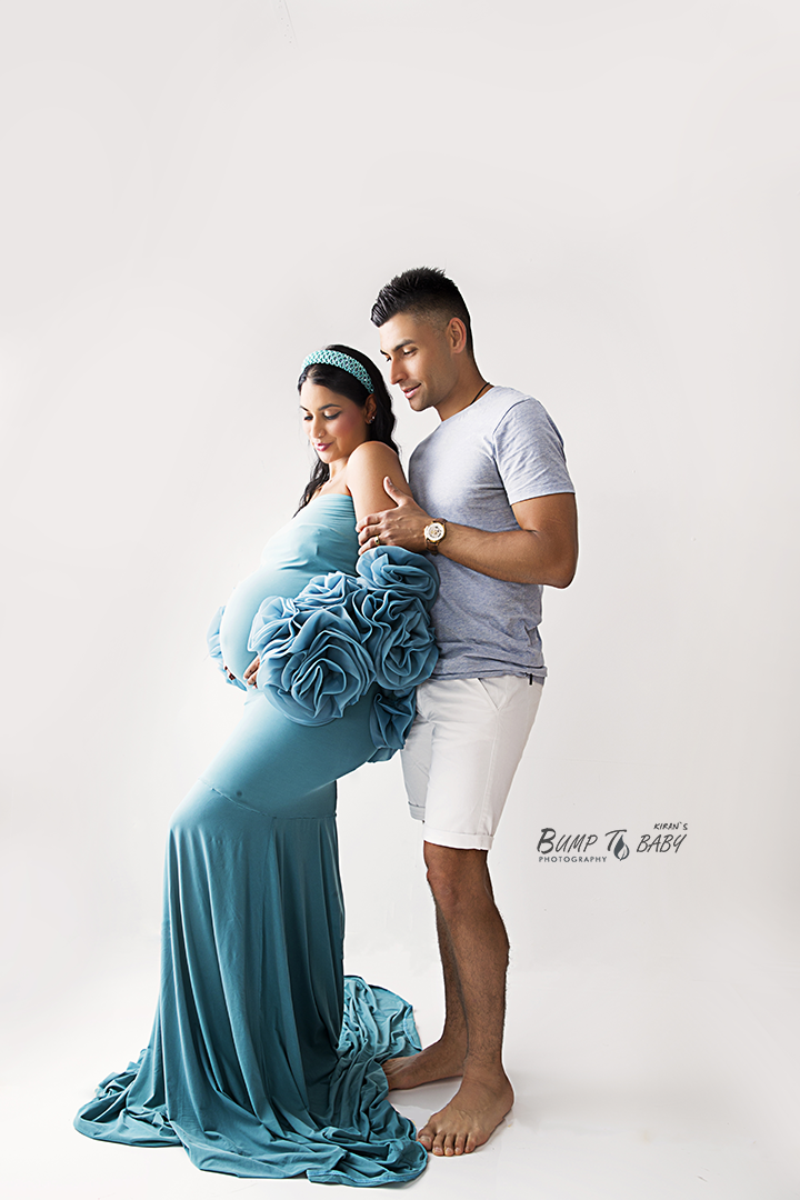 Husband embracing pregnant wife during maternity session in Melbourne