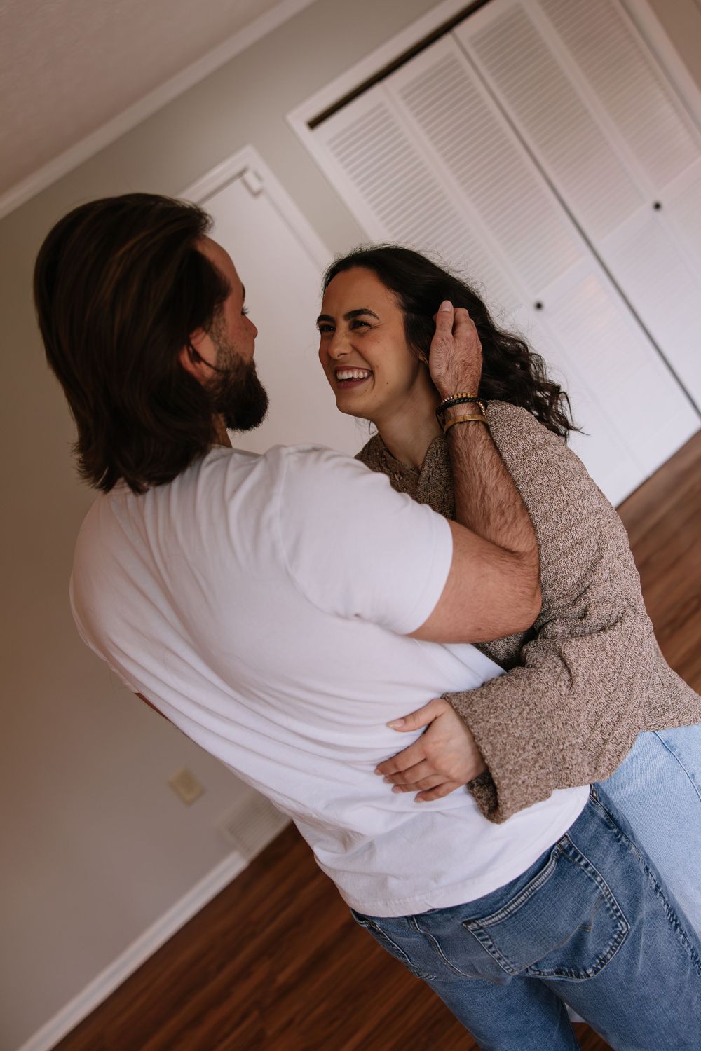 Couple sharing intimate moment while dancing together indoors.