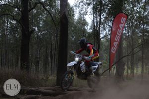 Motorbike jumping a log