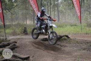 Motorbike jumping a log