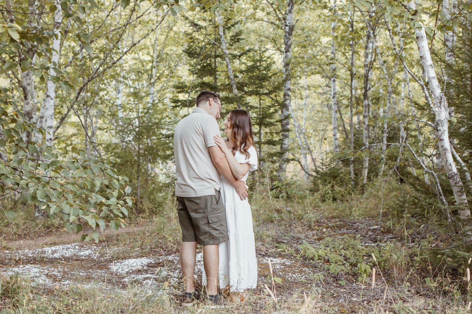 couples photoshoot at sunset, sun flare, kissing, holding each other, young love.