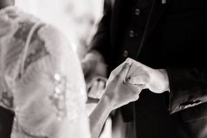 Artistic black and white close-up of flowing wedding dress fabric and veil details.