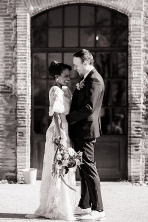Wedding couple sharing intimate moments against rustic brick archways in black and white photography sequence.
