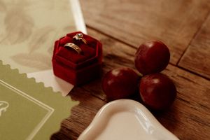Vintage toned image of rose petals and decorative elements on a rustic wooden surface.