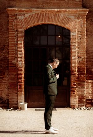 Series of brick archways in a rustic wedding venue showing a single figure standing in sequence.