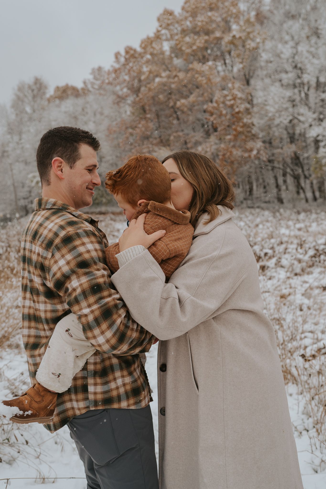 Intimate winter moments shared between loved ones in a snow-covered setting with warm clothing.