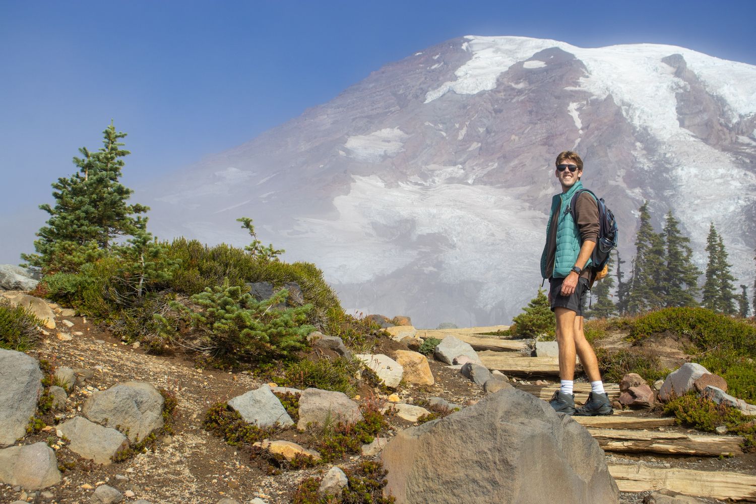 Hiking trail with snowy Mount Rainier peak visible in background.
