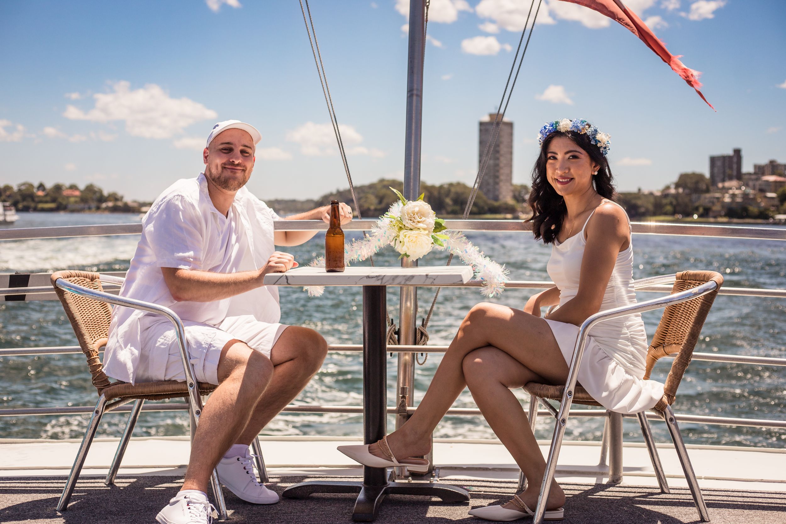 Casual bride and groom on board a boat in the Sydney Harbour on their wedding day