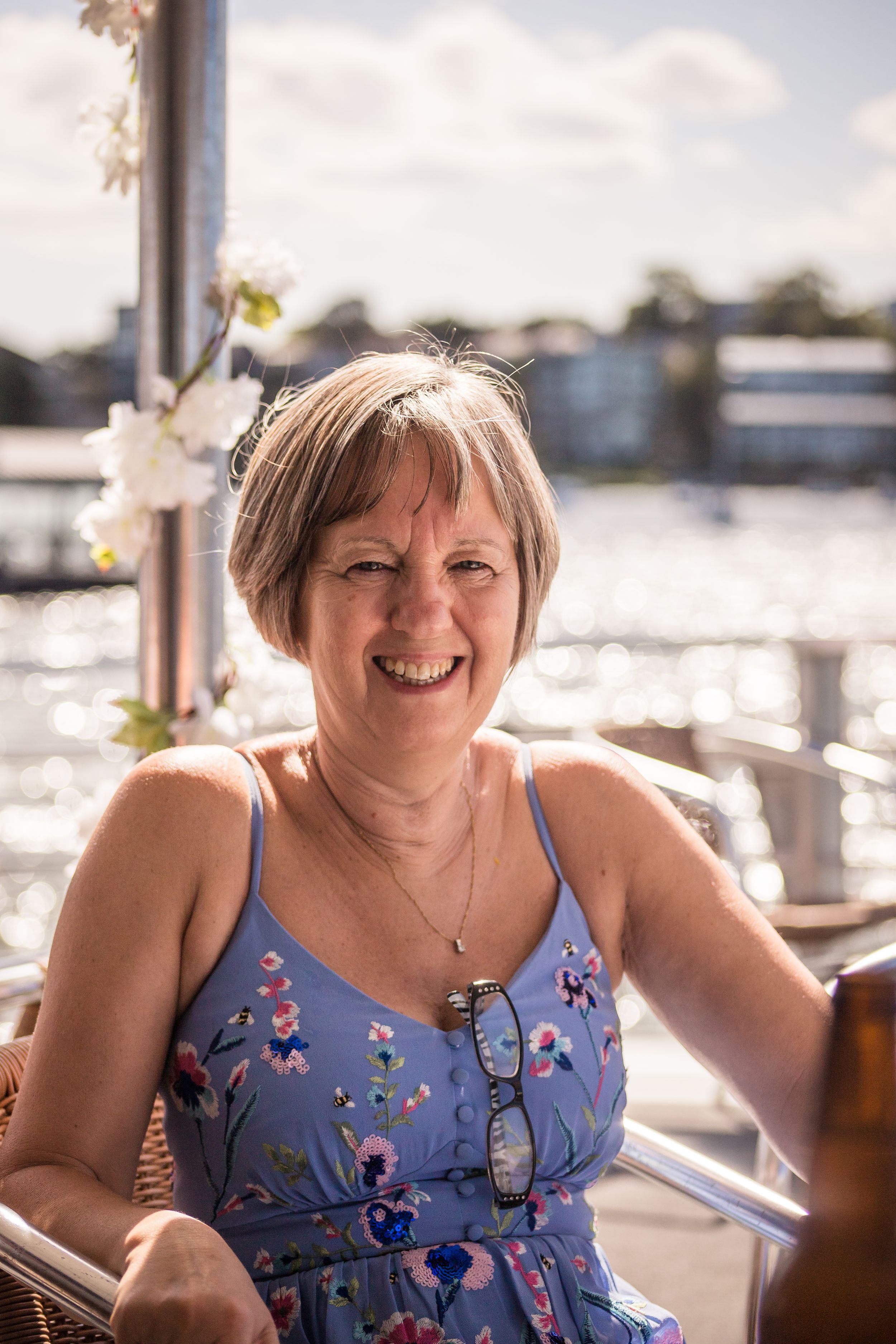Mother of the Groom enjoying the sunshine and happy on a boat in Sydney Harbour on relaxed wedding day
