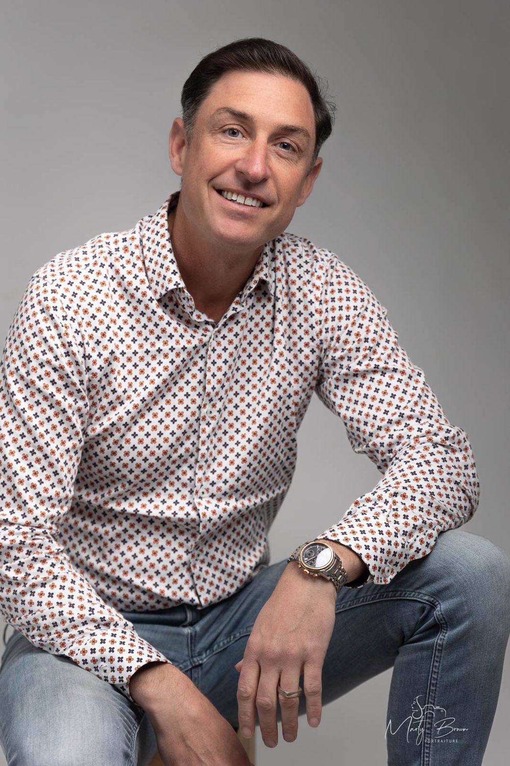 Corporate man in dress shirt sitting in studio portrait