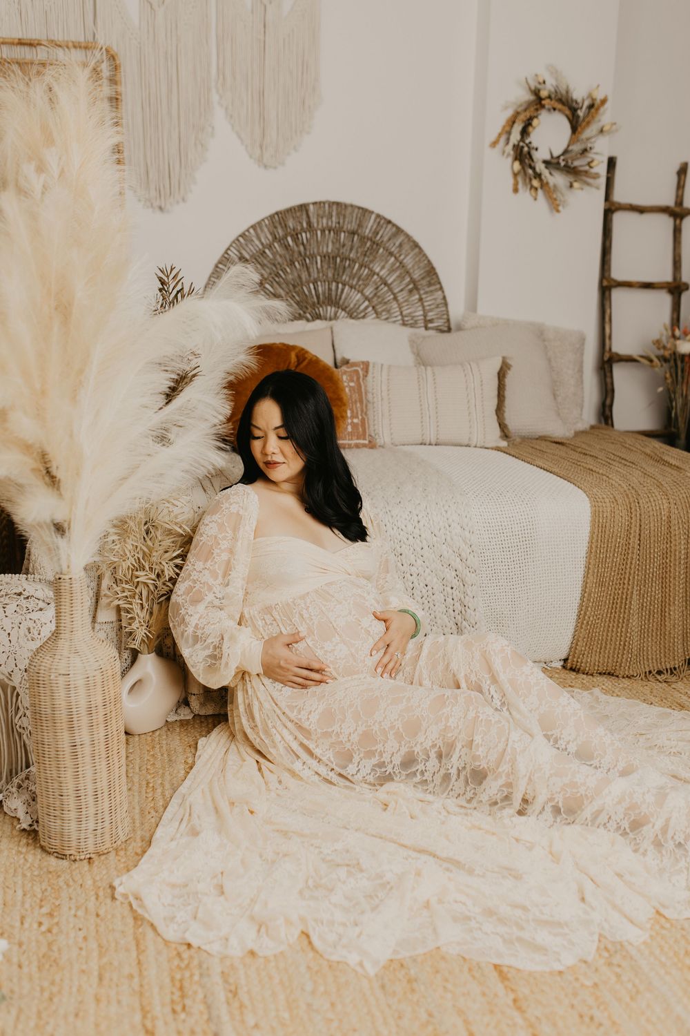 Romantic maternity portrait with vintage lace dress and soft neutral color palette.