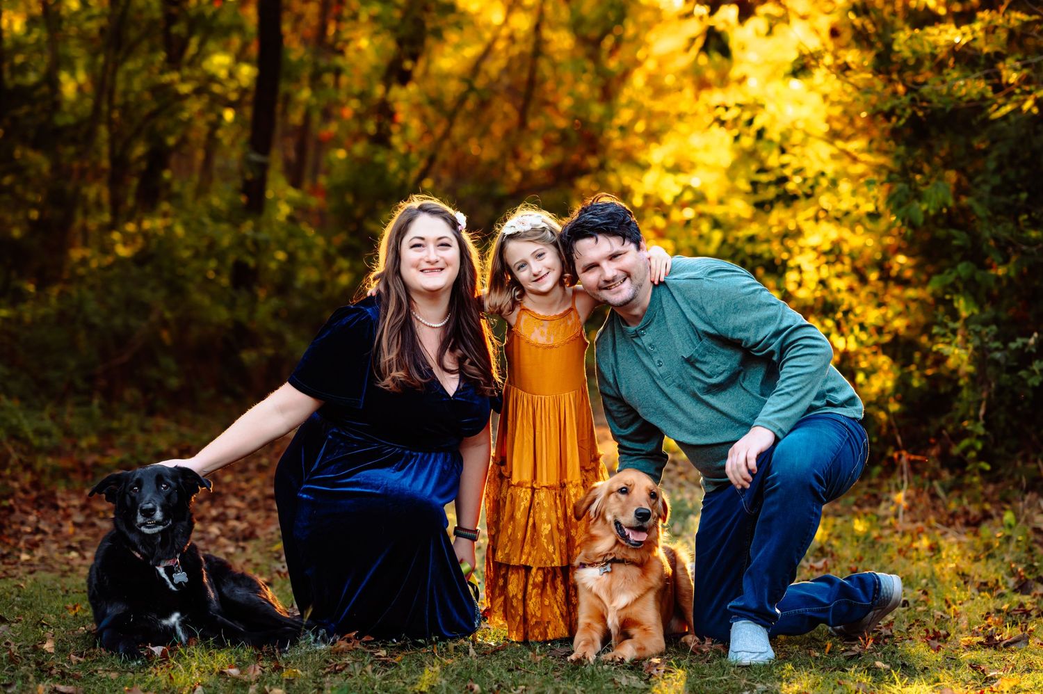 Plano family poses with daughter and dogs during sunset fall family photo session by mesquite tx family and newborn photographer