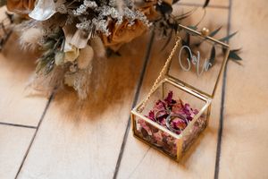 Rustic wooden boxes filled with dried flowers and vintage decor elements arranged on a light wooden surface.