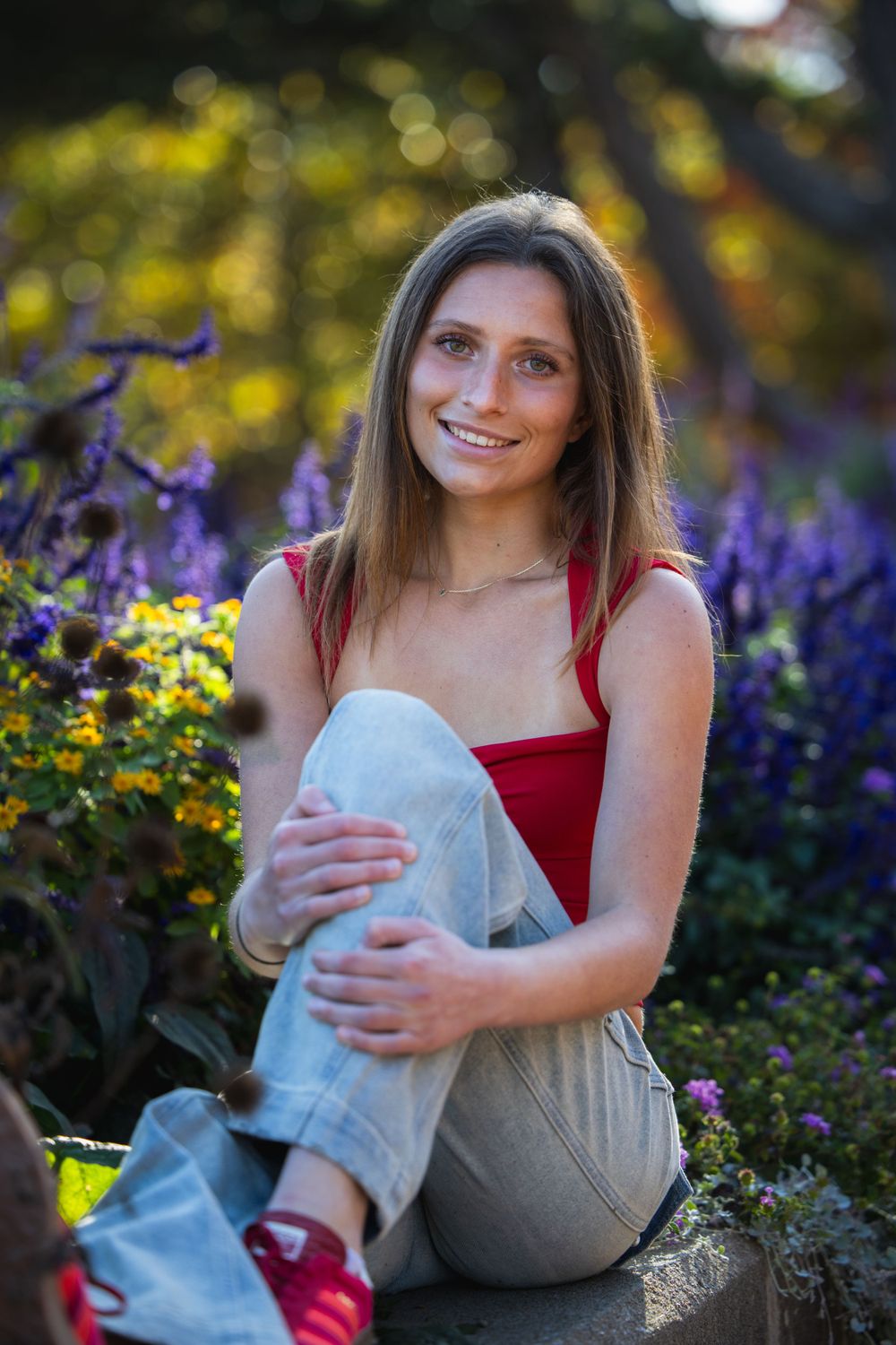 Senior girl in tank top among fall leaves, Faust Park fall senior photos St. Louis