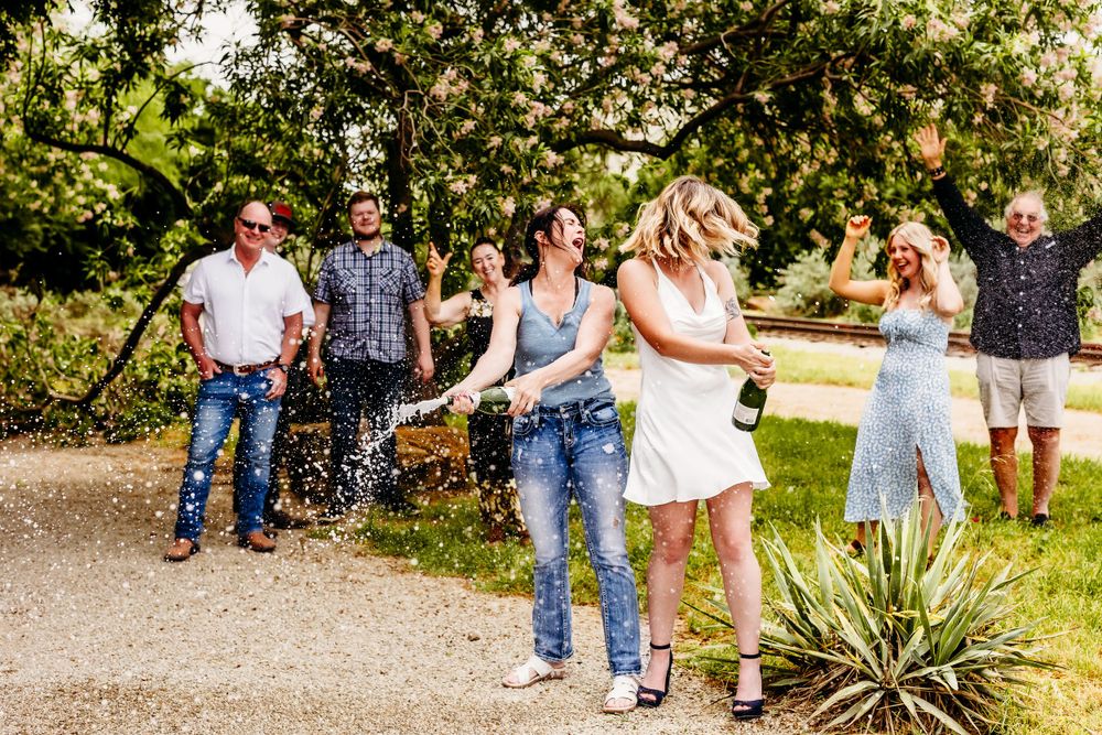 Candid group photo of people laughing and interacting on a garden path.